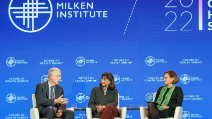one man and two women in chairs having a discussion