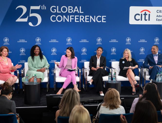 a panel of professional speakers in chairs having a discussion