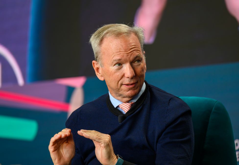 White professional male speaking on stage at conference